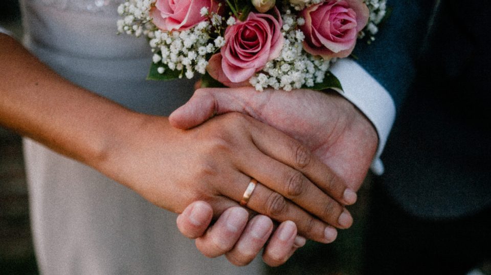 wedding-ring-hand-holding-bouquet