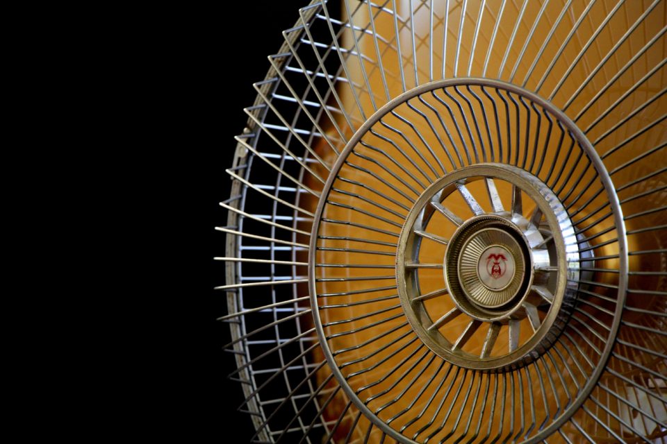 electric-fan-with-yellow-blades-black-background