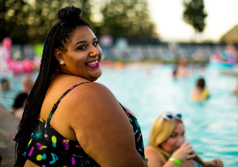 Black-woman-wearing-braids-swimsuit-at-swimming-pool.